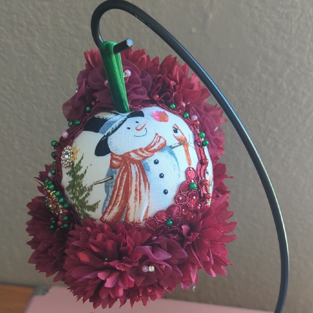 Festive Snowman Ornament with Red Floral Accents